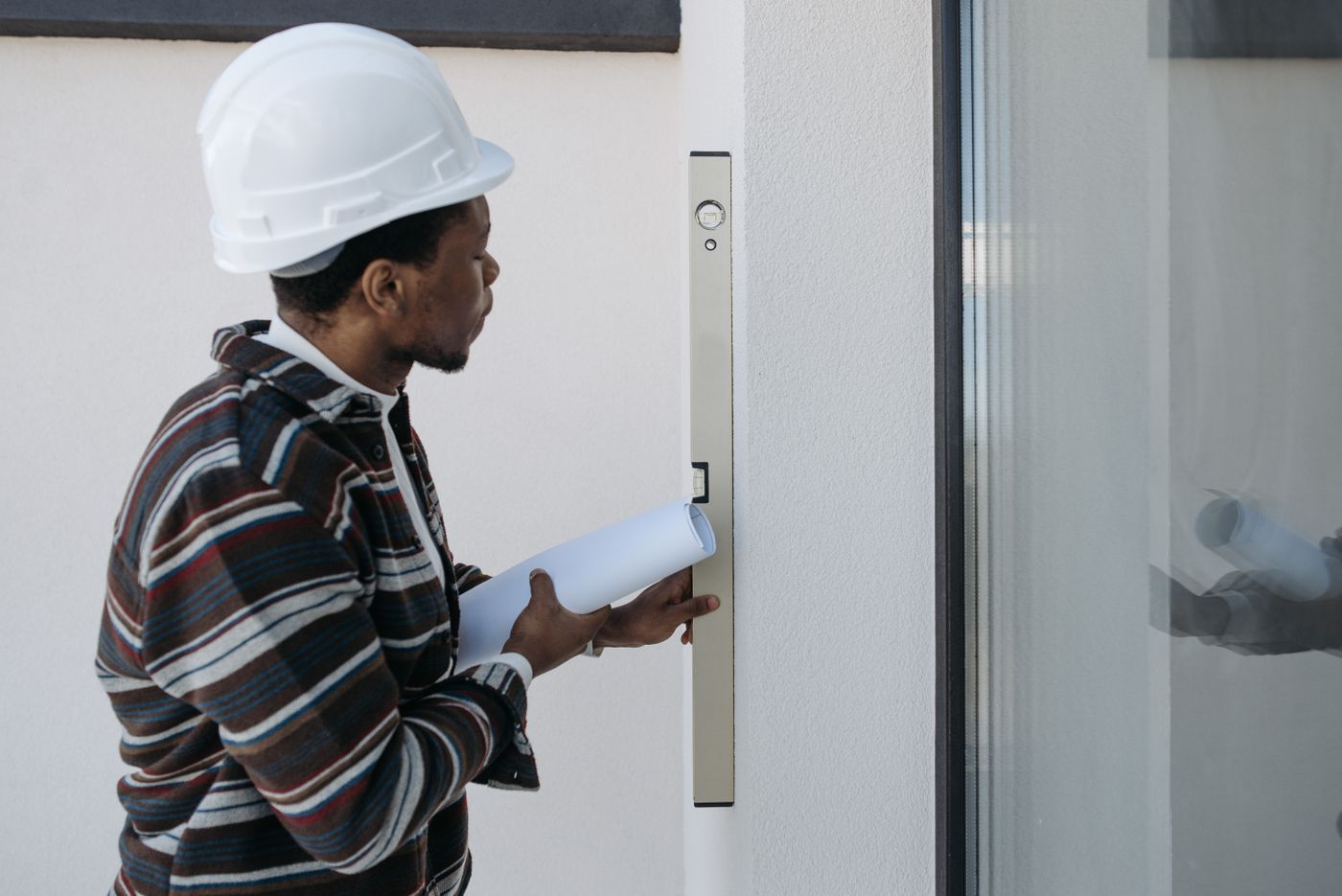Engineer checking a wall on site